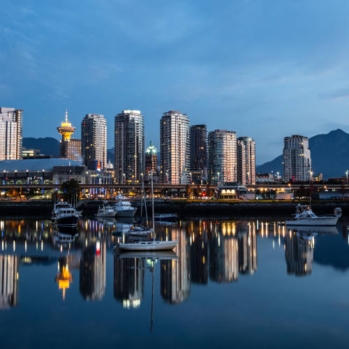 Morning Reflections Downtown Vancouver reflecting off the glass-like surface of False Creek early in the morning. The North Shore Mountains are in the background.
